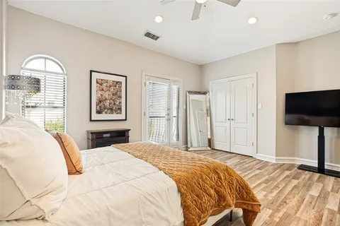 a bedroom with a bed and a flat screen tv