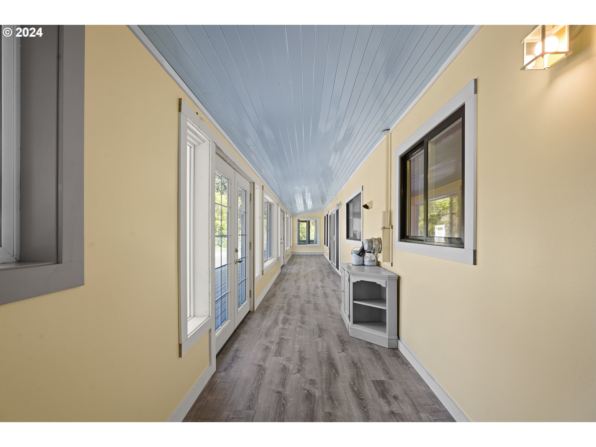 18787 Southeast Sunnyside Road Damascus, OR 97089 - Photo 17 of 36 a hallway with wooden floor fireplace and windows