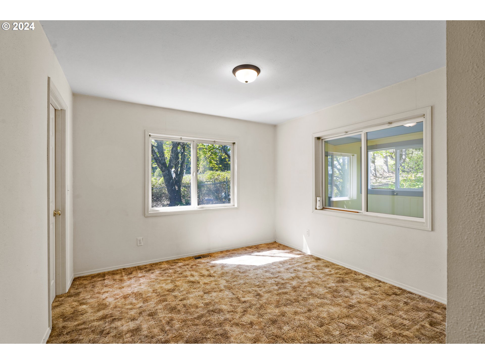 18787 Southeast Sunnyside Road Damascus, OR 97089 - Photo 21 of 36 a view of an empty room with a window