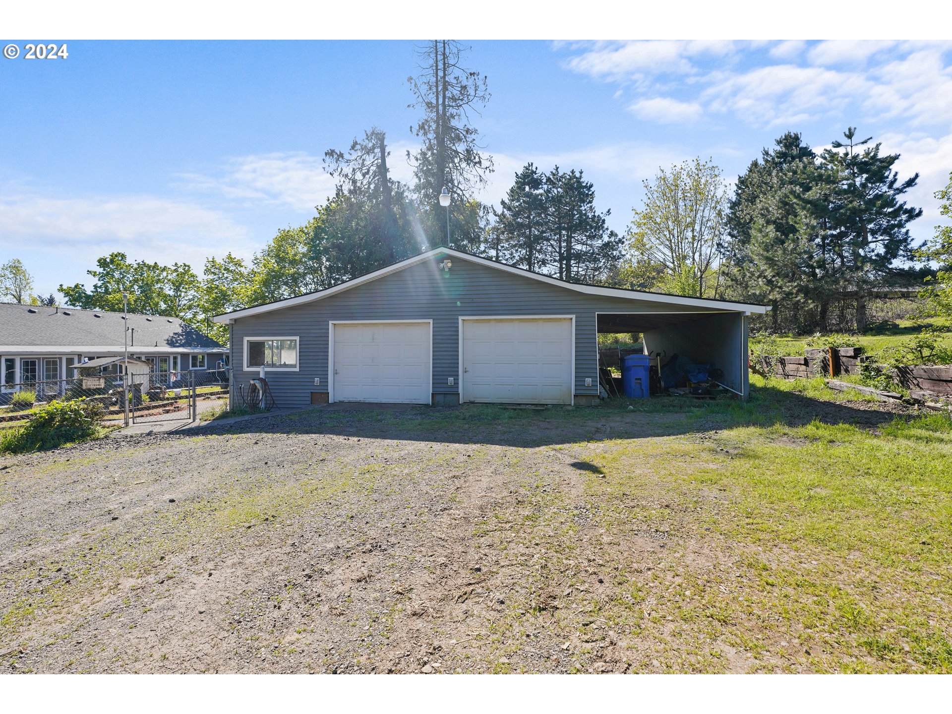 18787 Southeast Sunnyside Road Damascus, OR 97089 - Photo 28 of 36 a front view of a house with a yard and garage