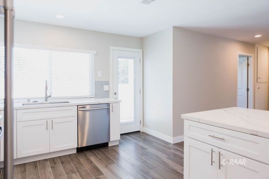 513 Suzanne Street Ridgecrest, CA 93555 - Photo 13 of 34 a kitchen with granite countertop white cabinets and white appliances
