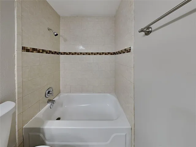 a bathroom with a tub and a shower