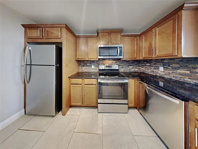a kitchen with appliances cabinets and a counter top space