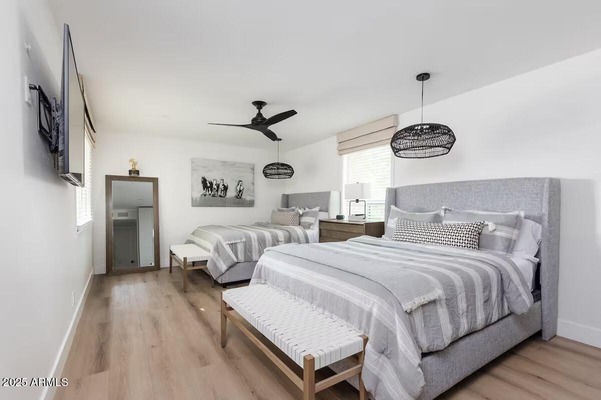 7625 East Camelback Road, Unit A252 Scottsdale, AZ 85251 - Photo 14 of 29 a bedroom with a bed and a chandelier