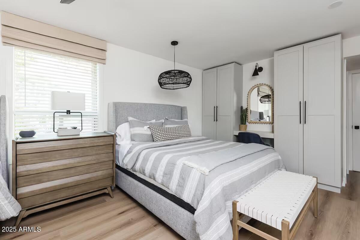 7625 East Camelback Road, Unit A252 Scottsdale, AZ 85251 - Photo 16 of 29 a bedroom with a bed and a chandelier