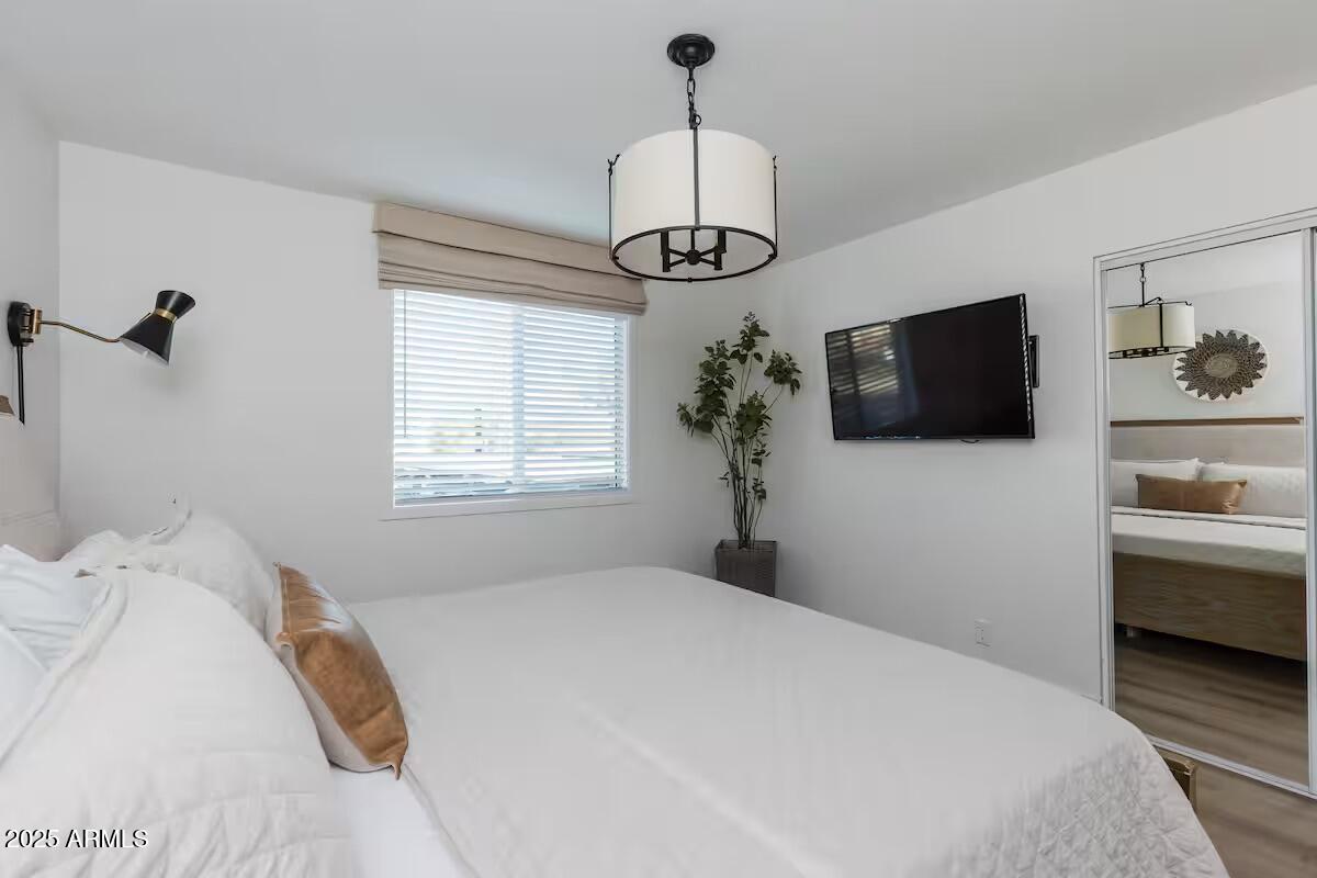 7625 East Camelback Road, Unit A252 Scottsdale, AZ 85251 - Photo 19 of 29 a bedroom with a bed and a flat screen tv