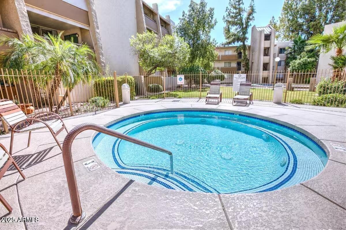 7625 East Camelback Road, Unit A252 Scottsdale, AZ 85251 - Photo 24 of 29 a swimming pool with outdoor seating and yard