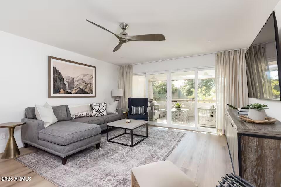 7625 East Camelback Road, Unit A252 Scottsdale, AZ 85251 - Photo 3 of 29 a living room with furniture and a large window
