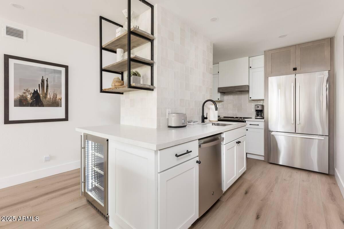 7625 East Camelback Road, Unit A252 Scottsdale, AZ 85251 - Photo 6 of 29 a kitchen with cabinets and stainless steel appliances