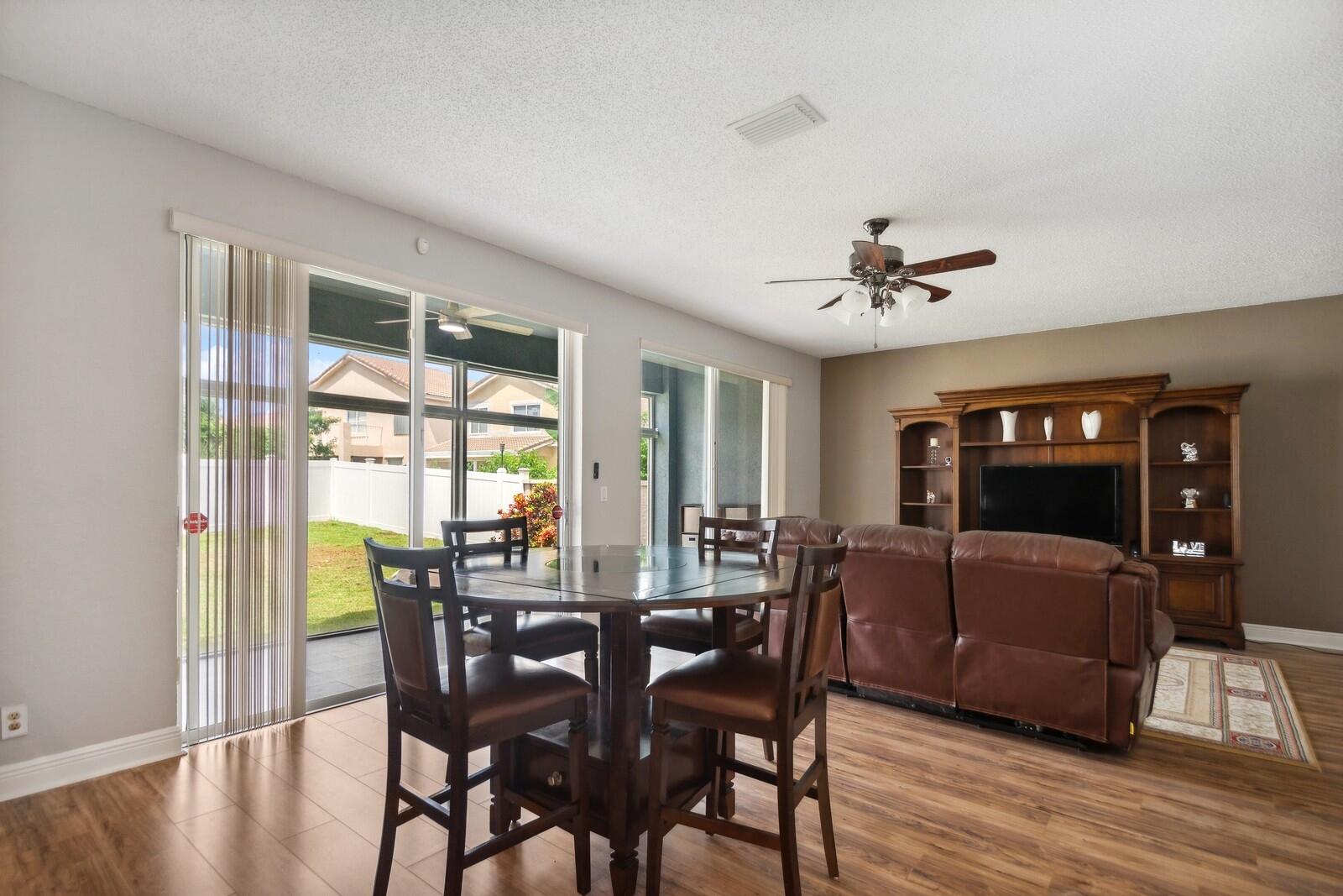 18287 Clear Brook Circle Boca Raton, FL 33498 - Photo 11 of 30 a view of a dining room with furniture window and wooden floor