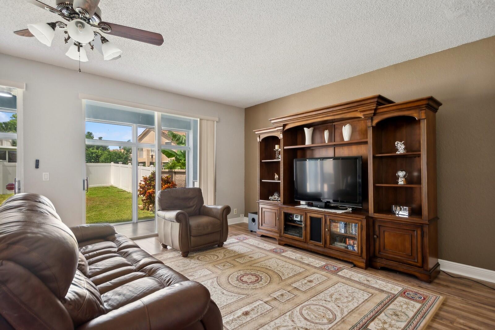 18287 Clear Brook Circle Boca Raton, FL 33498 - Photo 12 of 30 a living room with furniture and a flat screen tv