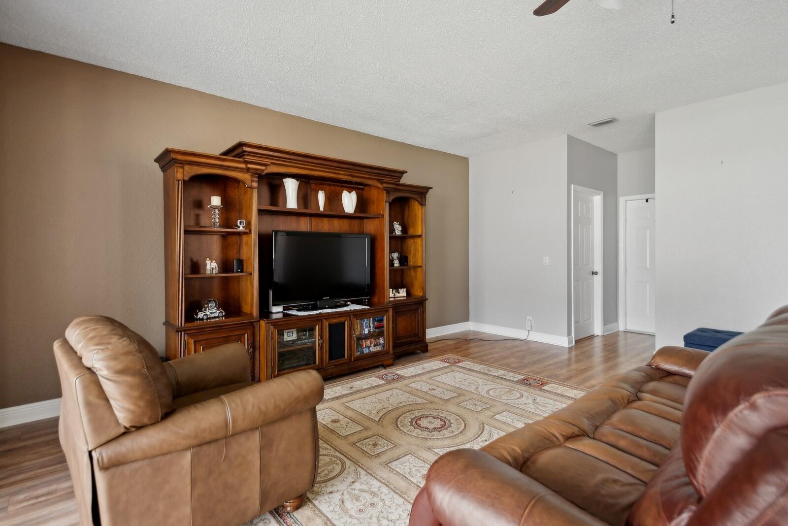 18287 Clear Brook Circle Boca Raton, FL 33498 - Photo 14 of 30 a living room with furniture and a flat screen tv