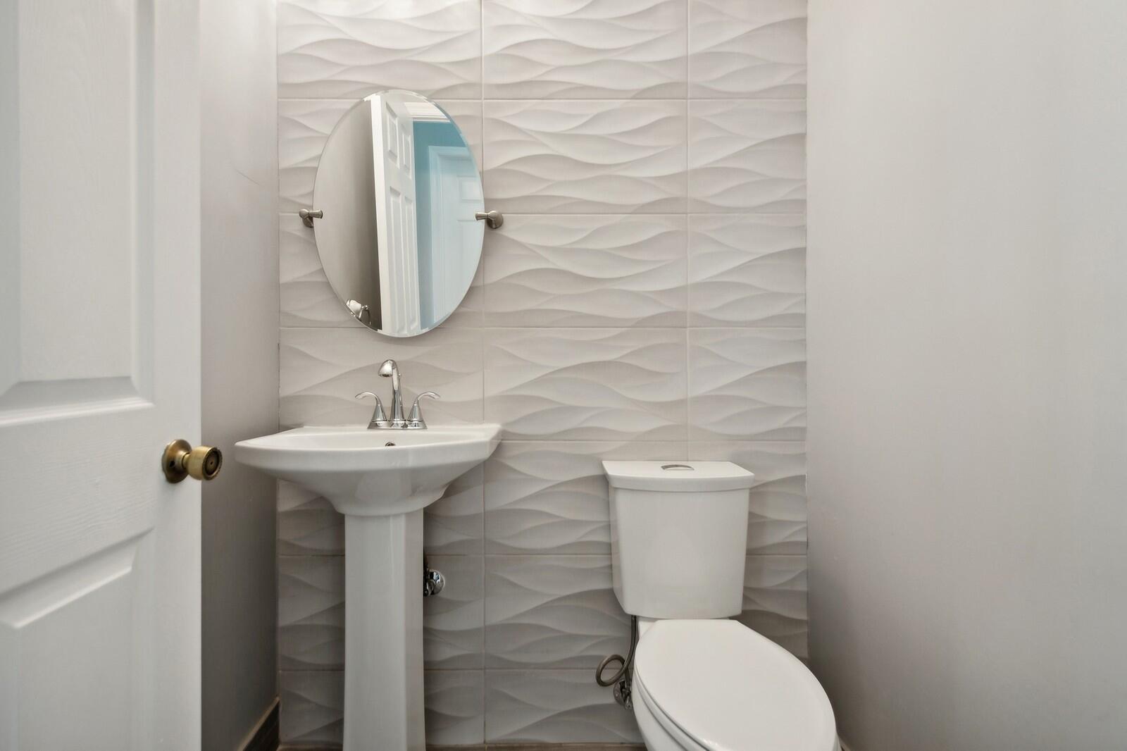 18287 Clear Brook Circle Boca Raton, FL 33498 - Photo 16 of 30 a bathroom with a toilet sink and mirror