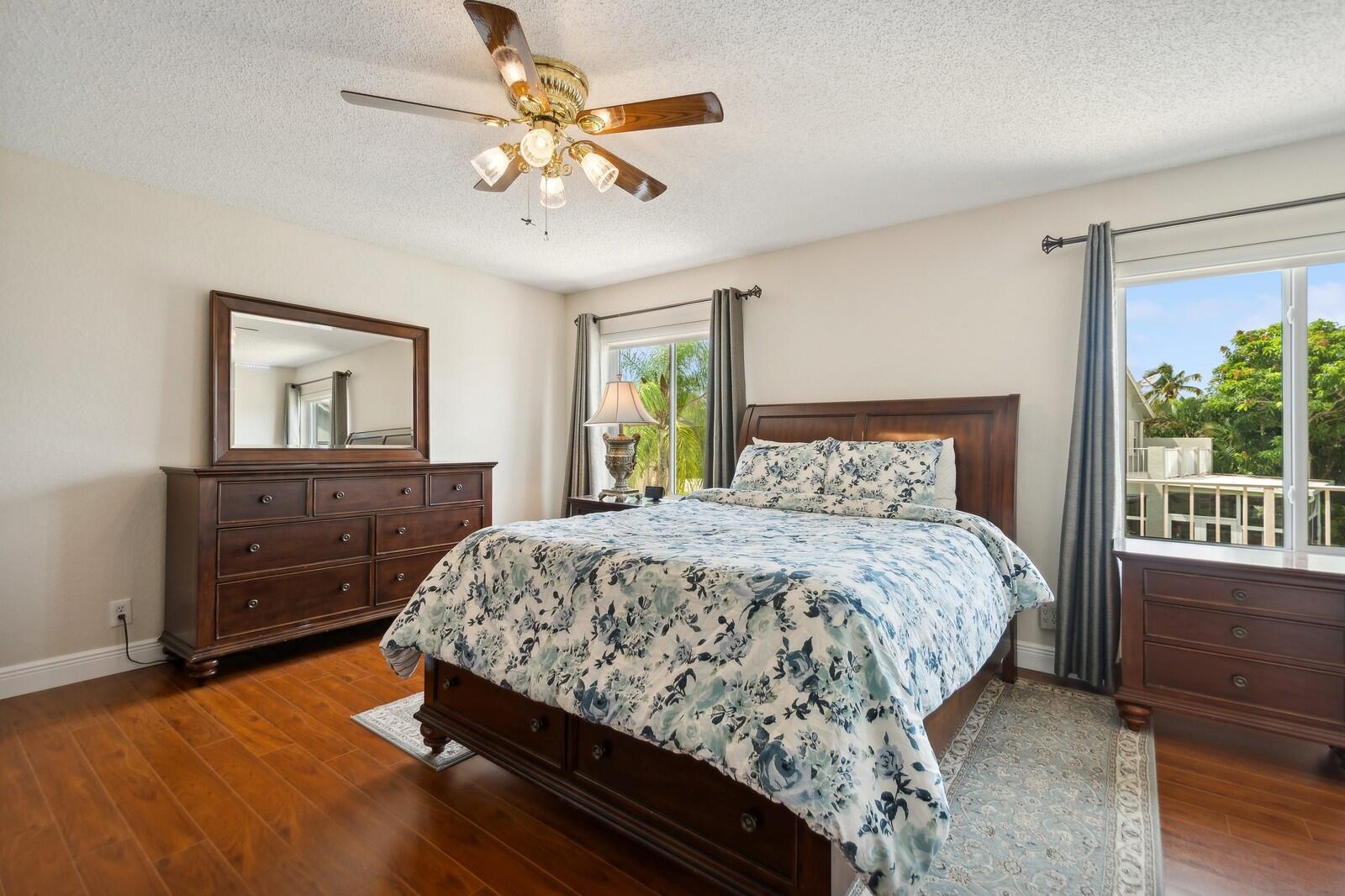 18287 Clear Brook Circle Boca Raton, FL 33498 - Photo 17 of 30 a bedroom with a large bed and a window