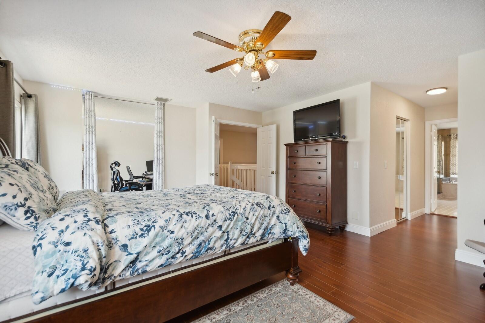 18287 Clear Brook Circle Boca Raton, FL 33498 - Photo 18 of 30 a bedroom with a bed and a flat screen tv