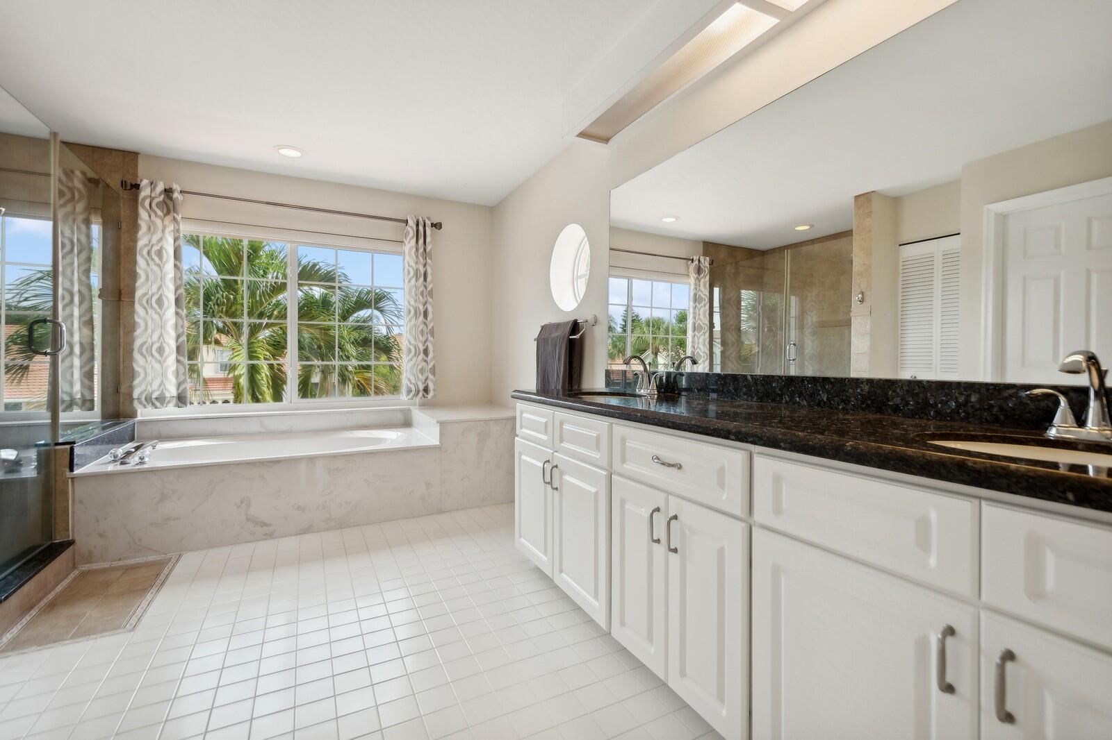 18287 Clear Brook Circle Boca Raton, FL 33498 - Photo 19 of 30 a bathroom with a granite countertop sink and a bathtub