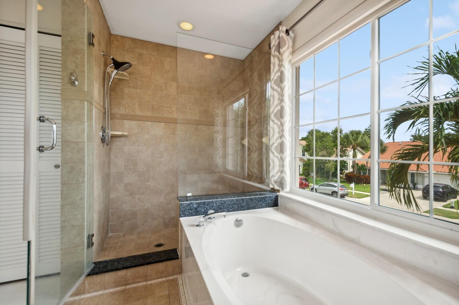 18287 Clear Brook Circle Boca Raton, FL 33498 - Photo 20 of 30 a bathroom with a bathtub and shower