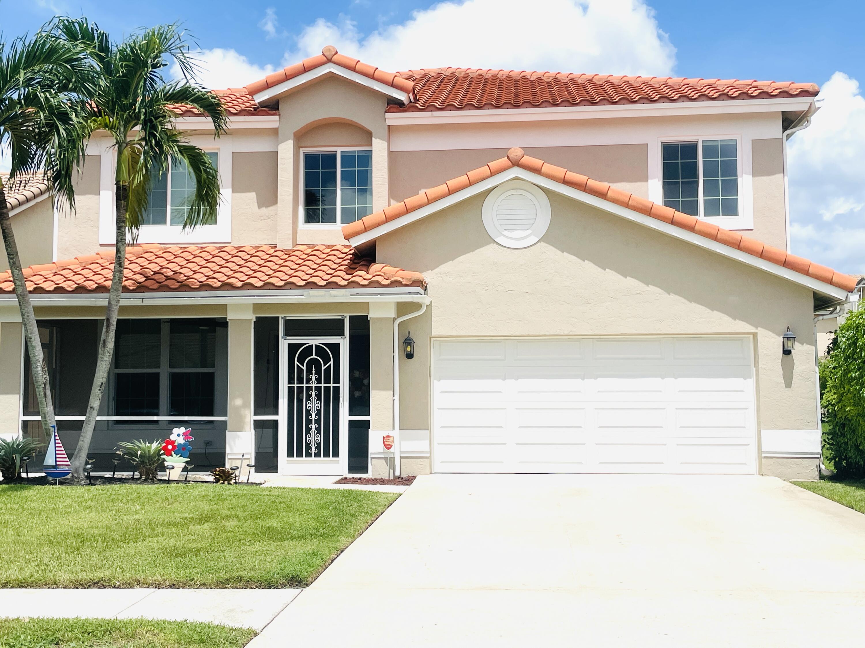 18287 Clear Brook Circle Boca Raton, FL 33498 - Photo 2 of 30 a front view of a house with a garden and plants