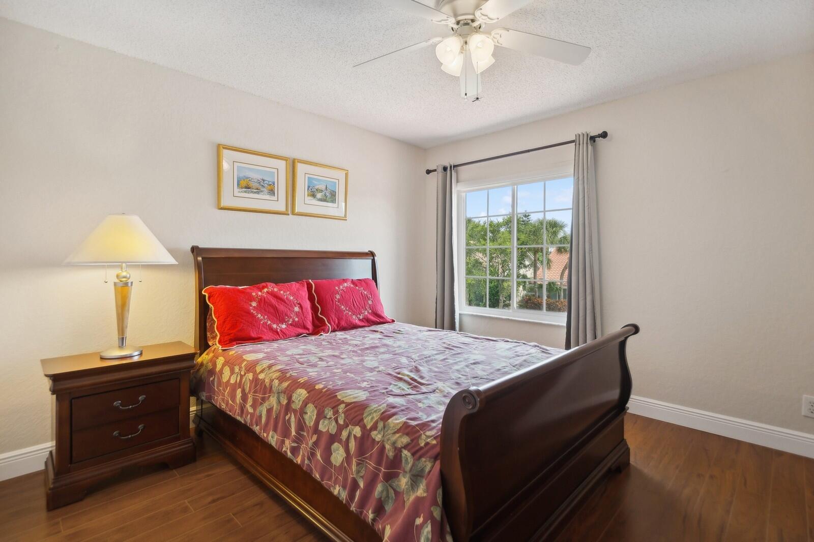 18287 Clear Brook Circle Boca Raton, FL 33498 - Photo 21 of 30 a bedroom with a bed and a window