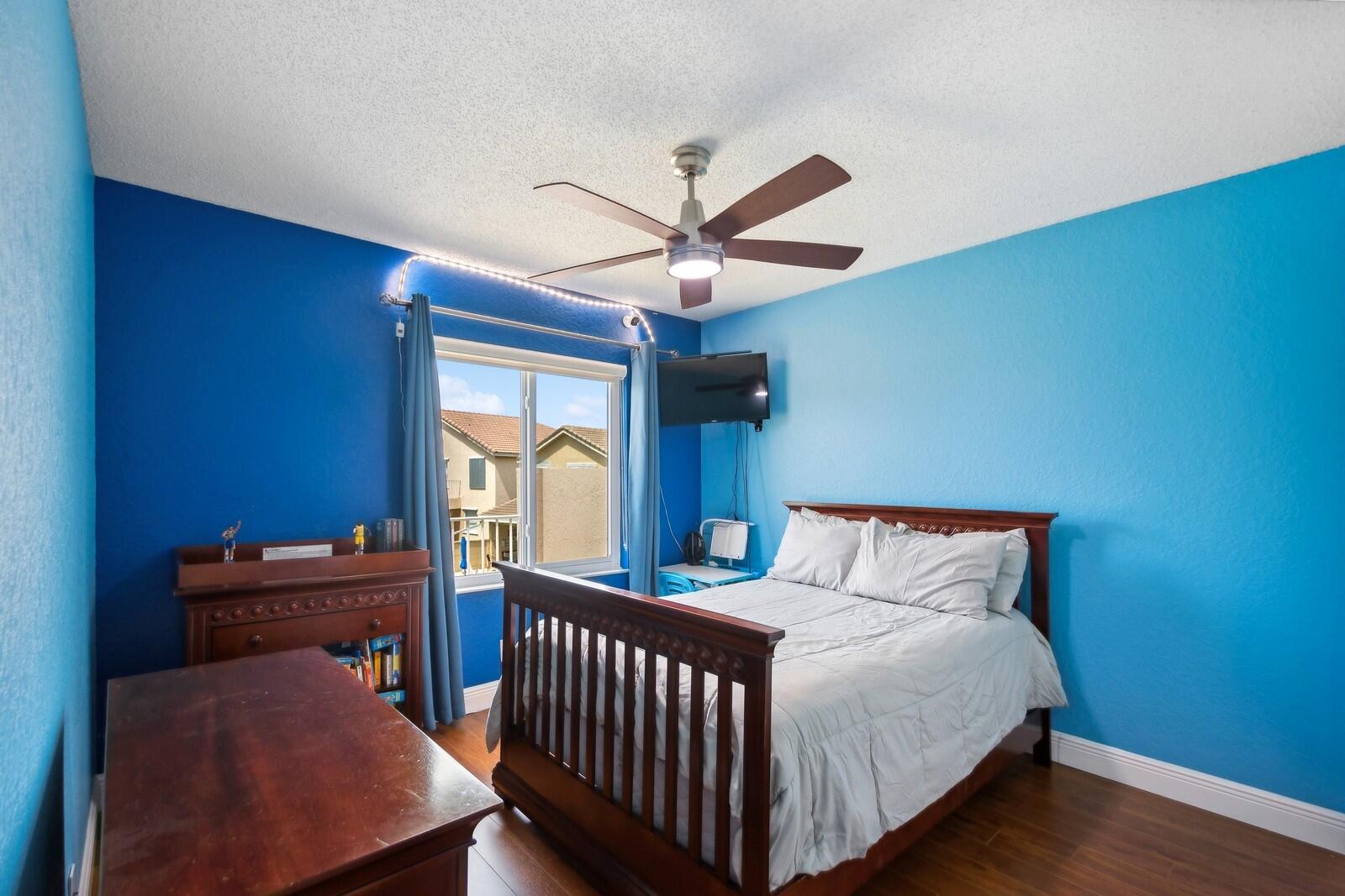 18287 Clear Brook Circle Boca Raton, FL 33498 - Photo 24 of 30 a bedroom with a bed and a chandelier