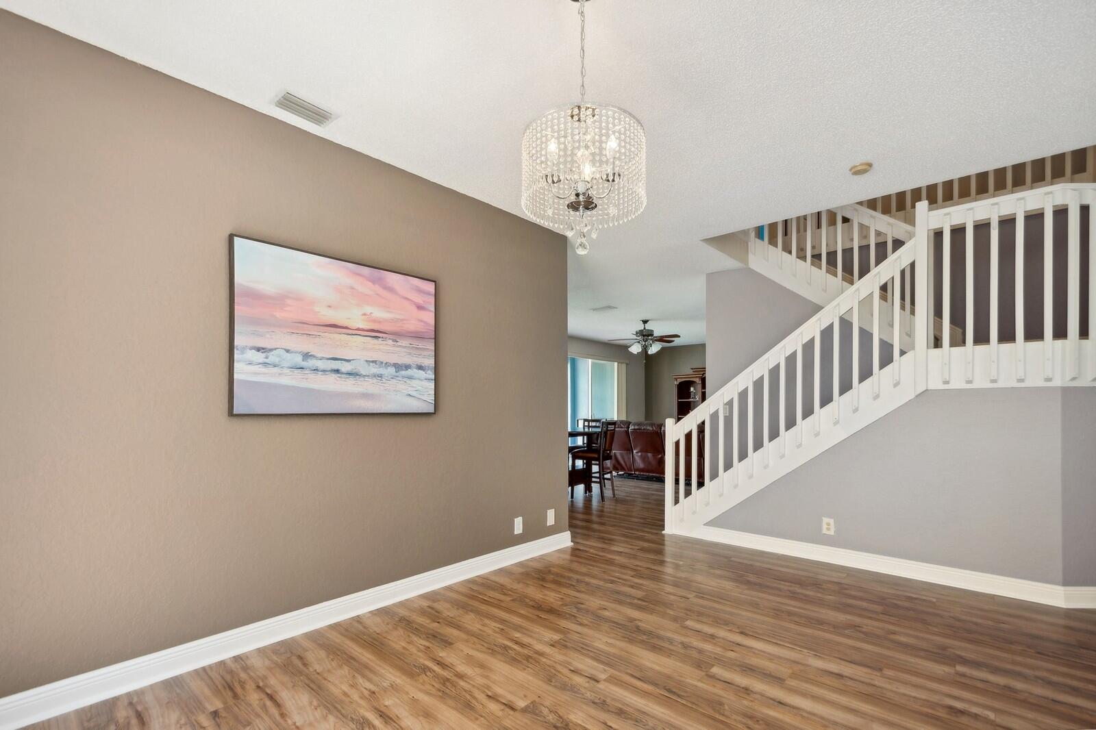 18287 Clear Brook Circle Boca Raton, FL 33498 - Photo 7 of 30 a view of a hallway with wooden floor and staircase