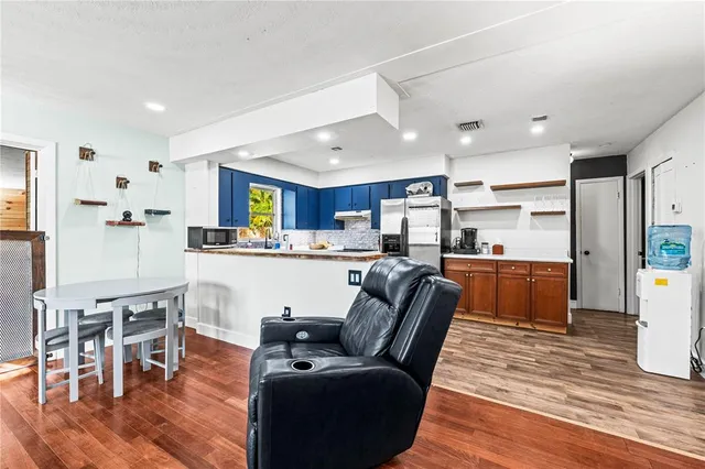 a kitchen with a sink refrigerator and cabinets