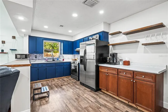 a view of kitchen with sink microwave and stove