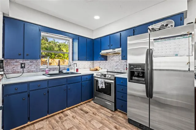 a living room with furniture a flat screen tv and a floor to ceiling window