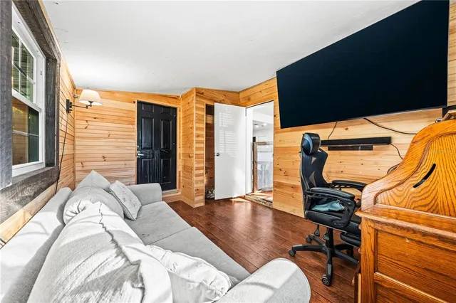 a bed sitting in a spacious bedroom next to a window