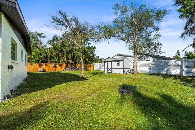 a backyard of a house with table and chairs