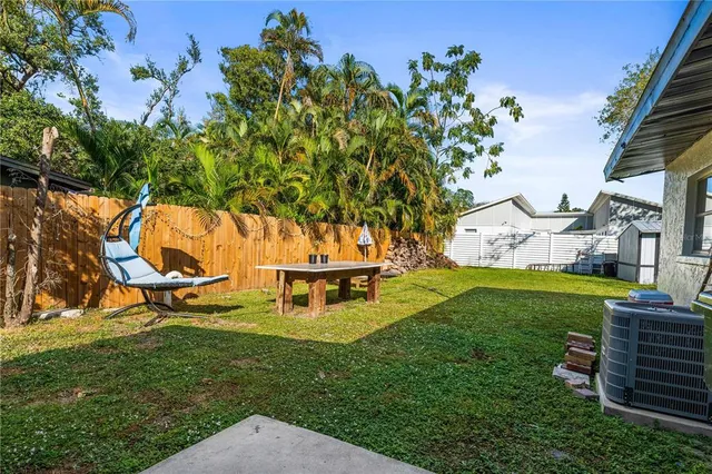 an aerial view of a house with a yard basket ball court and outdoor seating