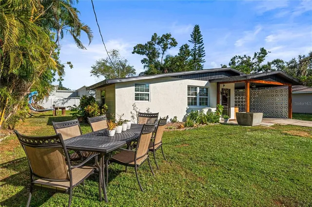 a view of a patio with table and chairs and potted plants