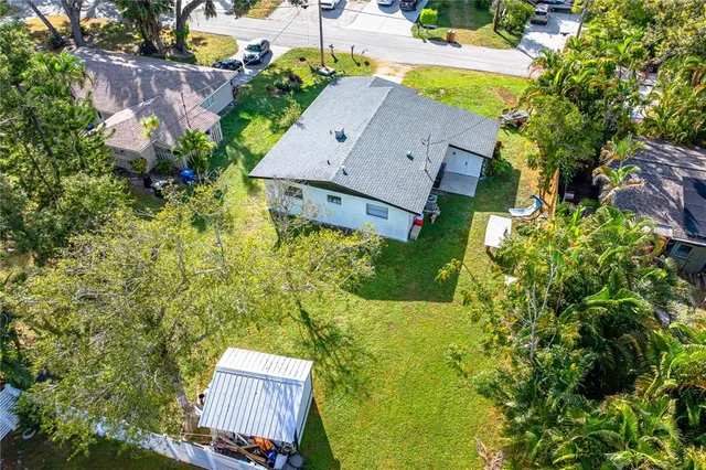 an aerial view of residential houses with yard
