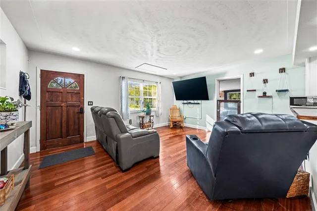 a bedroom with furniture and a flat screen tv