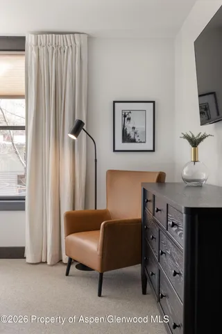 a bedroom with a large bed and a flat screen tv