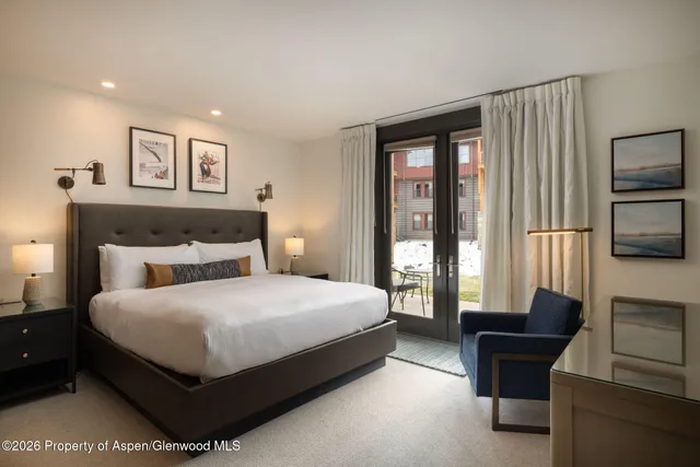 a bedroom with a large bed and a couch