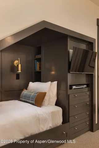 a bedroom with a bed and a dresser