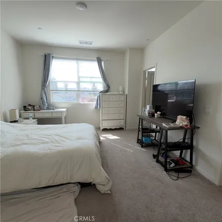 a bedroom with furniture and a window