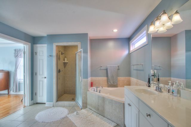 a bathroom with a bathtub a sink and a mirror