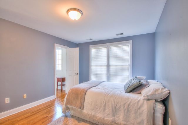 a view of room with window and wooden floor