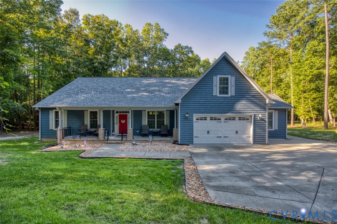 7075 Menzels Road Toano, VA 23168 - Photo 2 of 50 Blue siding exterior with an attached two-car gara