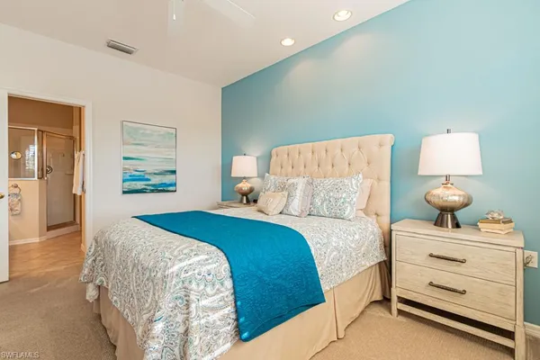 a bedroom with a bed and a lamp
