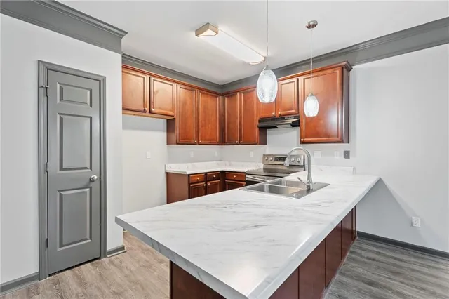 a kitchen with stainless steel appliances granite countertop a sink window and cabinets