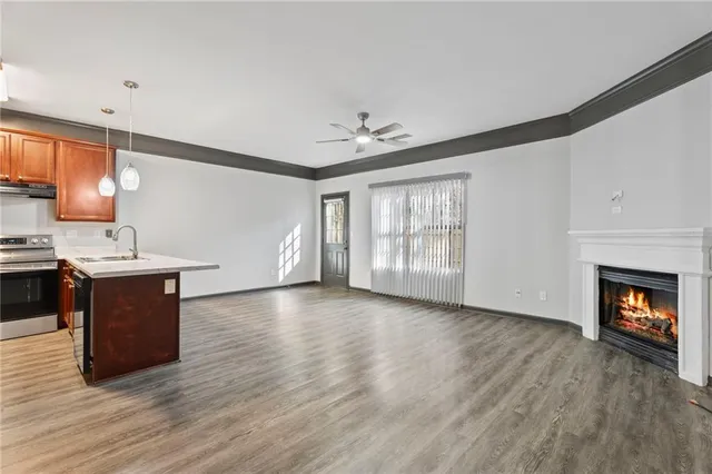 a view of kitchen with granite countertop stove top oven and cabinets