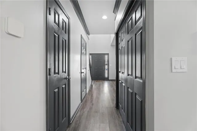 a view of a hallway with wooden floor and staircase