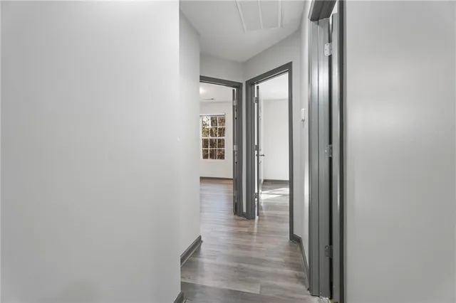 a view of a hallway with wooden floor