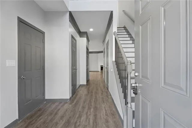 a view of a hallway with wooden floor and entryway