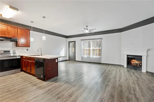 a kitchen with stainless steel appliances granite countertop a stove a sink and a refrigerator