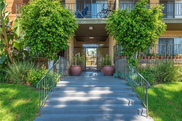a view of a porch with chairs and potted plants