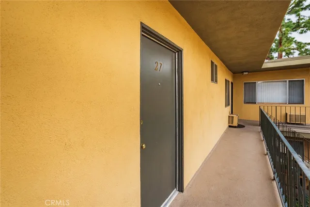 a view of a hallway with wooden floor and stairs